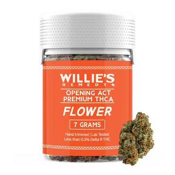 Jar of Willie's Remedy flower with an orange label and cannabis buds on a white background
